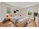 Serene main bedroom featuring natural light, hardwood floors, and minimalist decor at 6248 S Coventry Ln, Littleton, CO 80123