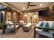 Outdoor living space featuring a modern fire pit, stylish seating, a brick wall and access to the landscaped backyard at 6248 S Coventry Ln, Littleton, CO 80123