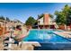 Inviting community pool area featuring a slide, sun loungers, and a two-story building with balcony overlooking the water at 6248 S Coventry Ln, Littleton, CO 80123