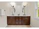 Bright bathroom featuring double vanity, shaker cabinets, and natural light at 6248 S Coventry W Ln, Littleton, CO 80123