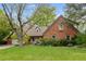 Charming brick home with a well-manicured lawn and mature trees offering curb appeal at 6248 S Coventry W Ln, Littleton, CO 80123
