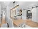 Dining room with modern chandelier, adjacent to staircase and office with sliding barn doors at 872 S Vine St, Denver, CO 80209