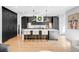 Sleek kitchen with dark cabinets, white countertops, and bar seating at 872 S Vine St, Denver, CO 80209
