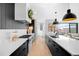 Modern kitchen with stainless steel appliances, black cabinets and large white countertop at 872 S Vine St, Denver, CO 80209