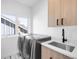 The laundry room features modern appliances, stylish cabinetry, and ample natural light at 872 S Vine St, Denver, CO 80209