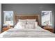 This well-lit main bedroom features a decorative headboard and matching bedside lamps, creating a cozy and stylish retreat at 872 S Vine St, Denver, CO 80209