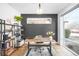 Bright office with large windows, rustic desk, dark accent wall, and modern shelving at 872 S Vine St, Denver, CO 80209