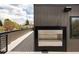 Rooftop patio with gray wood and dark modern fireplace feature with metal railing and views at 872 S Vine St, Denver, CO 80209