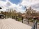 Large rooftop patio with black railings offering a great view of the neighborhood and sky at 872 S Vine St, Denver, CO 80209
