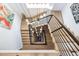 Unique birds eye view of wooden staircase with striking black metal railing and modern chandelier at 872 S Vine St, Denver, CO 80209