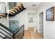 Open staircase with black railings and wood treads, complemented by hardwood floors and natural light at 872 S Vine St, Denver, CO 80209