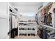 A bright walk-in closet with custom shelving for organized storage of clothing and shoes at 872 S Vine St, Denver, CO 80209