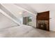 Living room features carpet, stone fireplace, staircase, and balcony access at 4896 S Dudley St # 8-11, Littleton, CO 80123