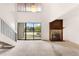 Bright living room with stone fireplace, high ceilings, and sliding door to balcony at 4896 S Dudley St # 8-11, Littleton, CO 80123