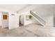 Bright open floorplan living room with staircase and adjacent kitchen area at 4896 S Dudley St # 8-11, Littleton, CO 80123