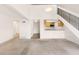 Open concept living room featuring high ceilings, staircase, and partial kitchen view at 4896 S Dudley St # 8-11, Littleton, CO 80123