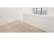 Carpeted loft area with natural light from the window at 4896 S Dudley St # 8-11, Littleton, CO 80123