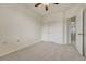 Carpeted bedroom with neutral colors, a ceiling fan, and closet at 16051 E Geddes Dr # 66, Aurora, CO 80016