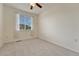 Bright bedroom with a ceiling fan, carpeted floors, and a window with decorative curtains at 16051 E Geddes Dr # 66, Aurora, CO 80016