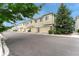 Inviting townhomes feature attached garages, neutral siding and lush, mature trees along a quiet street at 16051 E Geddes Dr # 66, Aurora, CO 80016