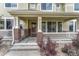 Inviting front porch with brick accents, steps, and a charming entryway to a lovely townhome at 16051 E Geddes Dr # 66, Aurora, CO 80016