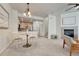 Open-concept living room with a dining area, fireplace, and a glimpse of the kitchen, perfect for modern living at 16051 E Geddes Dr # 66, Aurora, CO 80016