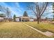 Expansive backyard with a lush lawn and a covered patio, ideal for entertaining at 365 W Peakview Ave, Littleton, CO 80120