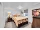 Cozy bedroom with a patterned bedspread, side table, and natural light from the window at 365 W Peakview Ave, Littleton, CO 80120