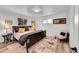 Inviting bedroom featuring hardwood floors, natural lighting, and a comfortable seating area at 365 W Peakview Ave, Littleton, CO 80120