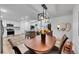 Stylish dining area featuring a wooden table and chairs under a modern chandelier, leading to the updated kitchen at 365 W Peakview Ave, Littleton, CO 80120