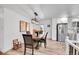 Elegant dining area featuring a wooden table and chairs under a modern chandelier, with access to the kitchen at 365 W Peakview Ave, Littleton, CO 80120