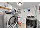 Well-equipped laundry room featuring a washer, dryer, utility sink, and ample space at 365 W Peakview Ave, Littleton, CO 80120