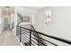 Modern upstairs hall with sleek metal railing and a contemporary light fixture at 8277 Butte Creek St, Littleton, CO 80125