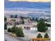 Stunning aerial view showcasing the home, neighborhood, and mountain vistas at 10353 N Chatfield Dr, Littleton, CO 80125
