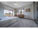 Bright bedroom featuring ample light from the windows and a dresser with storage at 10353 N Chatfield Dr, Littleton, CO 80125
