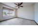 Minimalist bedroom with a large window and ceiling fan, offering ample natural light at 10353 N Chatfield Dr, Littleton, CO 80125