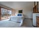 Bright bedroom features a sliding glass door leading to a deck with scenic outdoor views at 10353 N Chatfield Dr, Littleton, CO 80125