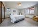 Comfortable bedroom with natural light, a plush bed, and ample closet space at 10353 N Chatfield Dr, Littleton, CO 80125