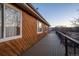 The deck has an exterior home wall with windows, and a cable-wire railing at 10353 N Chatfield Dr, Littleton, CO 80125
