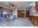Open dining area with a wood table, ceiling fan, and access to storage and other rooms at 10353 N Chatfield Dr, Littleton, CO 80125