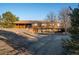 Charming wood home on a hill, featuring a private setting with mature trees at 10353 N Chatfield Dr, Littleton, CO 80125