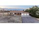 Ranch-style home with three-car garage, landscaped front yard, and mountain views at 10353 N Chatfield Dr, Littleton, CO 80125