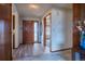 Foyer with wooden door and flooring leading into the home at 10353 N Chatfield Dr, Littleton, CO 80125