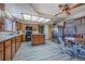 Well-lit kitchen with wood cabinets, stainless steel appliances, and an adjacent dining space at 10353 N Chatfield Dr, Littleton, CO 80125