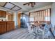 Bright kitchen and dining area with wood cabinets, stainless steel refrigerator, and modern lighting at 10353 N Chatfield Dr, Littleton, CO 80125