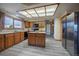 Spacious kitchen featuring wood cabinets, modern appliances, and an open layout at 10353 N Chatfield Dr, Littleton, CO 80125