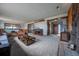 Spacious living room with a rock fireplace and large windows at 10353 N Chatfield Dr, Littleton, CO 80125