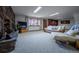 Living room features fireplace and stone wall, large windows with outdoor views, and comfortable seating at 10353 N Chatfield Dr, Littleton, CO 80125