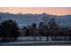 Scenic evening view of a quiet neighborhood street with mountain backdrop at 10353 N Chatfield Dr, Littleton, CO 80125