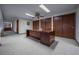 Spacious office area with a large wooden desk, ample storage, and soft carpet at 10353 N Chatfield Dr, Littleton, CO 80125